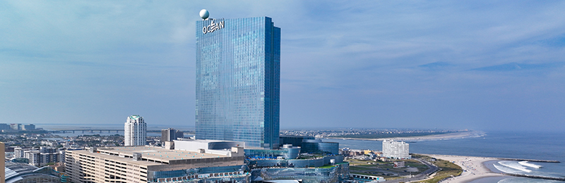 A picture of a tall, modern building with an ocean backgdrop, the Nobu hotel Atlantic City at Caesars, in Atlantic City, New Jersey