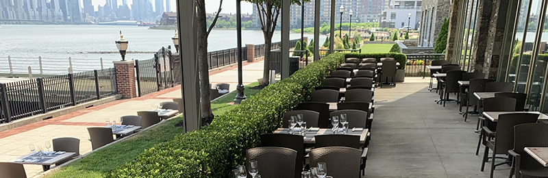 A porch with outdoor seating at Haven restaurant in Edgewater, New Jersey, on the banks of the Hudson river