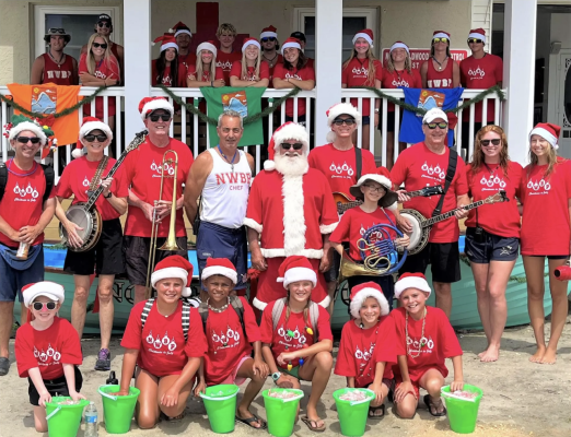 group of lifeguards dressed as elves and Santa in the summer