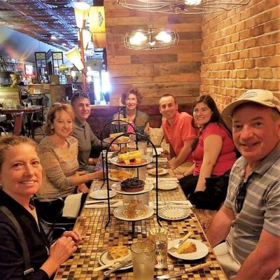 group smiling at the table while dining along the tour